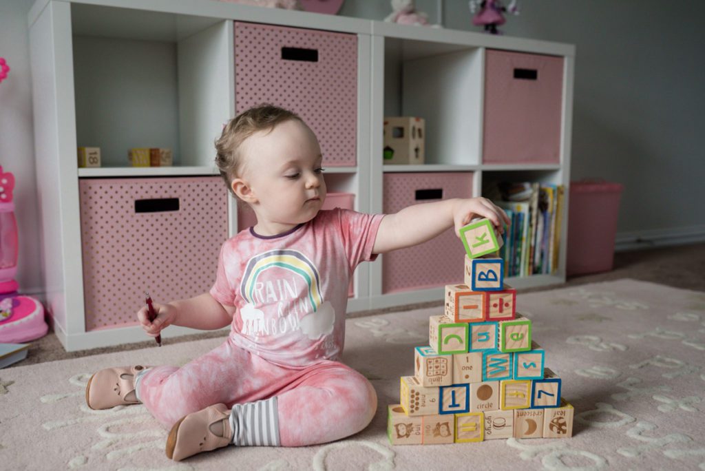 baby girl playing with wooden blocks