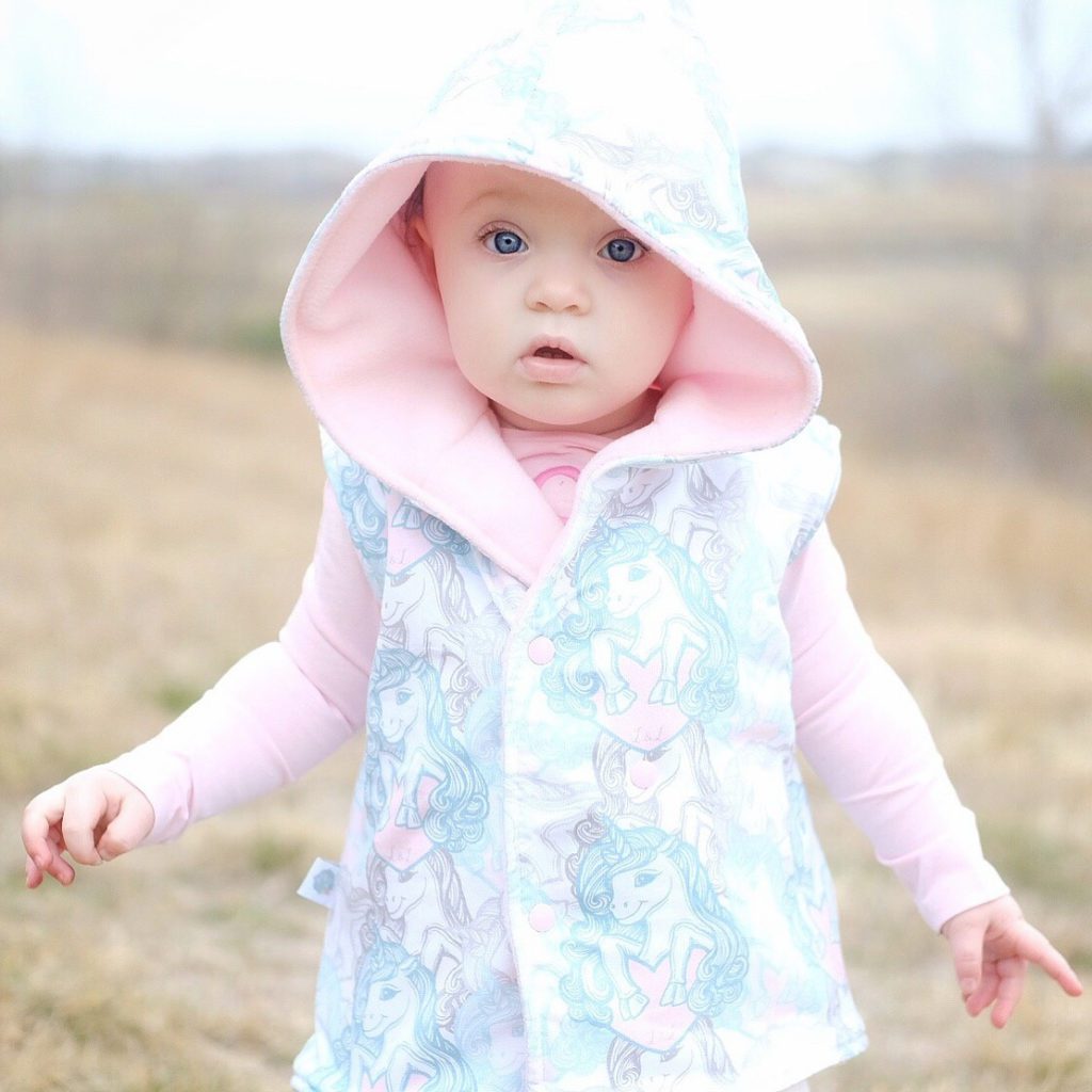 baby girl outside in unicorn jacket