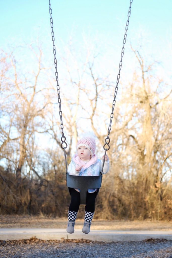 child on a swing outside