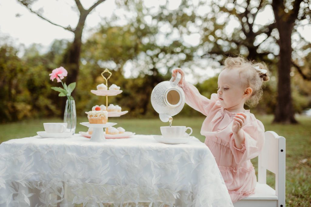 child playing pretend tea party